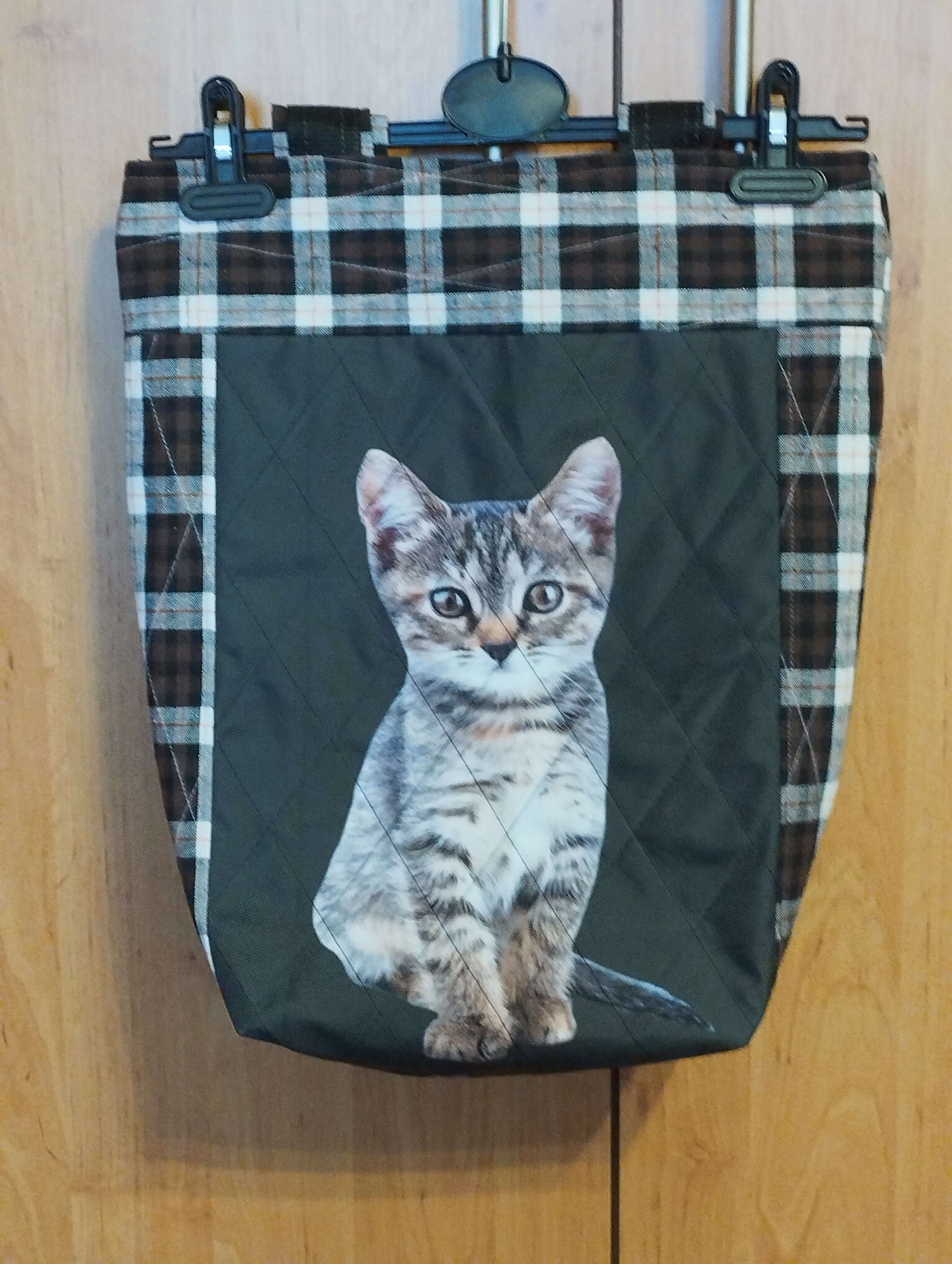 Stylish cat-themed bag featuring a quilted design and a cute kitten print against a checkered background.